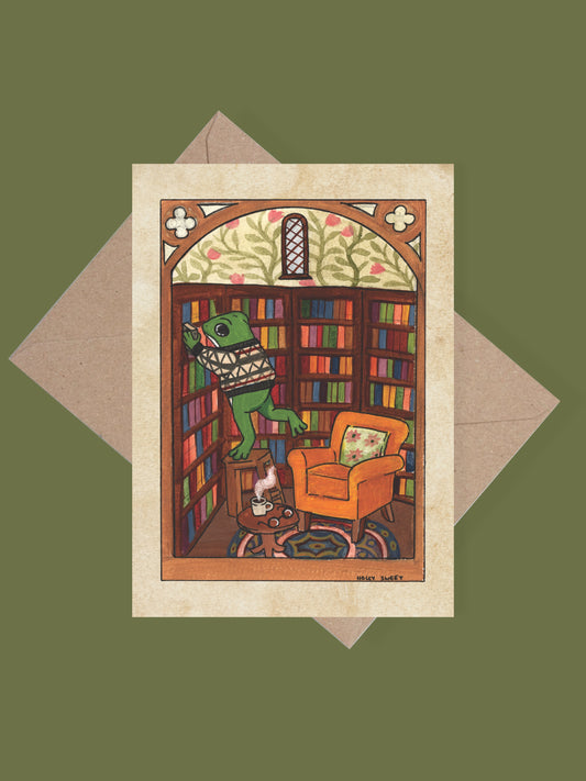 Frog in a library cosy greetings card